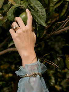 Models hand wearing various Elizabeth Allardyce Stacker Rings and the Foo Dog Bracelet