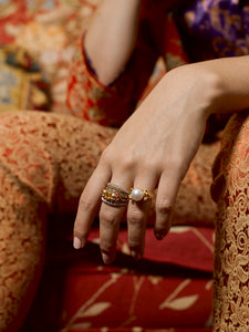 Close up of models hand wearing the Stacker Rings and Pearl Ring