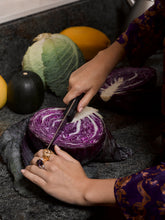 Load image into Gallery viewer, Model cutting into a cabbage wearing various rings