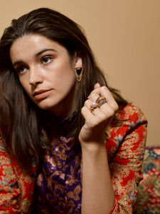 Model wearing various Elizabeth Allardyce Stacker Rings and Obelisk Earrings